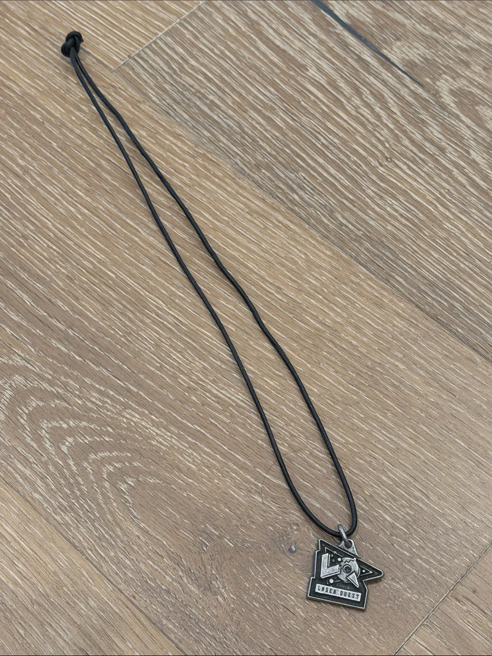 Vintage 1990s “Laser Quest” Black Cord Necklace with Metal Badge Pendant